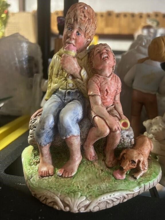 Painted Figurine of Two Boys and a Dog on a Rock